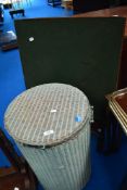A vintage Lloyd Loom linen basket and a folding card table