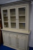 A modern neutral painted book or display cabinet having sideboard base, dimensions approx. W154cm