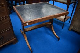 A stained frame coffee table having blue leather top and Regency style frame