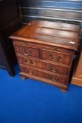 A reproduction Regency dwarf chest of two over two drawers, with brushing slide
