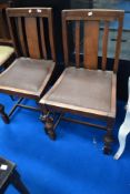 Two mid 20th Century oak dining chairs