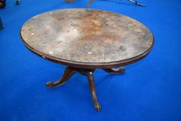 A Victorian oval table having quarter veneered walnut top on turned column, quadrupl shaped legs and