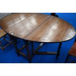 An early 20th Century oak twist gateleg dining table having oval top