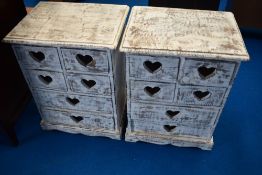 A pair of modern shabby chic style bedside cabinets with heart motifs to drawer