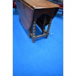 A period oak drop leaf dining table having turned gate legs