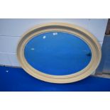A vintage oval wall mirror