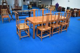 An Oriental hardwood dining table and set of eight (six plus two) dining chairs