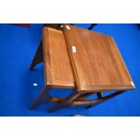 A nest of two vintage teak occasional tables of stylised form