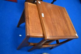 A nest of two vintage teak occasional tables of stylised form