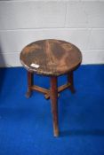 A Chinese/Arts and Crafts style three legged stool having interesting tri stretcher