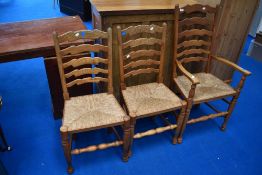 Three traditional ladder back chairs having rush seats (two plus one)