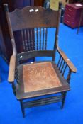 A 19th Century stained frame armchair having spindle back and arm supports