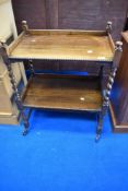 An early 20th Century oak tea trolley having twist frame