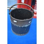 A vintage brass coal bucket
