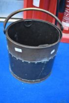 A vintage brass coal bucket