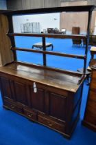 A period oak dresser having open delft rack, kist style base with lift lid and drop panels over