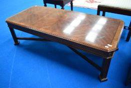 A reproduction yew wood coffee table, approx. 142 x 63cm