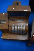 A vintage metal cash register (wood effect finish)
