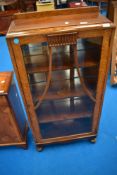 A mid 20th Century oak display cabinet of compact proportions