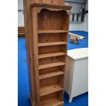 A modern narrow pine shelf unit