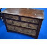 A late 19th or early 20th Century mahogany and walnut chest of two over two drawers