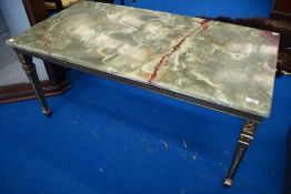 An onyx topped coffee table, as found, approx. 56 x 107cm, having gilt legs