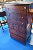 A modern hardwood stag style bedroom chest of tall drawers
