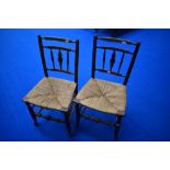 A pair of 19th Century spindle back kitchen chairs having rush seats