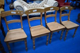 A set of four Georgian style stripped solid seat dining chairs