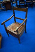 A late 19th Century stained frame commode carver chair