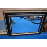 A vintage ebonised and gilt frame wall mirror