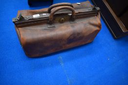 A vintage leather gladstone bag