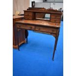 An Edwardian mahogany and inlaid dressing table or desk having central mirror flanked by two