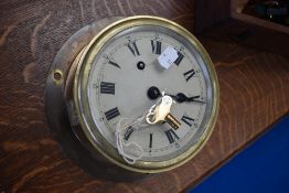 A vintage brass ship style 'porthole' clock