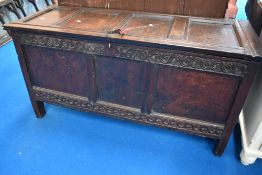 A period oak kist having panelled lid and base, carving to frieze VB and 1670