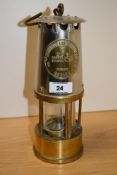 A stainless steel Eccles Type 6 miner's lamp, with applied brass manufacturer's plaque, measuring
