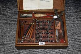 A vintage leather making kit, with punch and assorted tools.