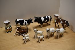 Two Beswick cow ornaments, a pair of miniature toby jugs, two Beswick foals, and a family of six