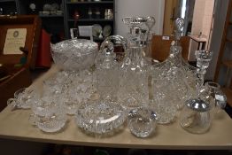 A large collection of cut glass and similar, including decanters, flower baskets, punch mugs and
