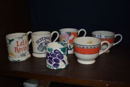 Five Emma Bridgwater mugs, including floral and grape patterns and two with orange banding and black