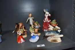 A small collection of figural ornaments, by Goebel, Royal Doulton, to include a Christmas Morning