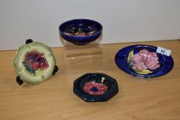 Three William Moorcroft ashtrays, in the Anemone, Magnolia, and Hibiscus patterns, together with