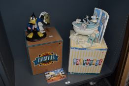 A 1990s Looney Tunes 'Lifestyles Of The '90s' Workaholic Daffy Duck sculpture, with box, and another