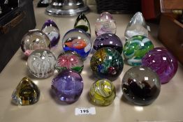 Sixteen paperweights, various colours and shapes, including Caithness.