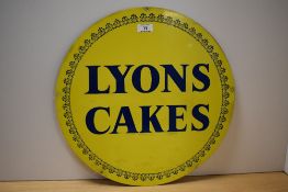 A Lyons Cakes blue on yellow enamelled advertising sign, 43cm diameter