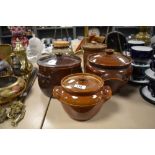 A selection of crock pots and storage jars, including antique earthenware examples.