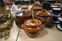 A selection of crock pots and storage jars, including antique earthenware examples.