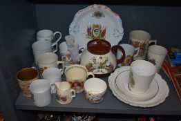 A collection of antique coronation ware, including teapot, beakers and mugs, predominantly 1902