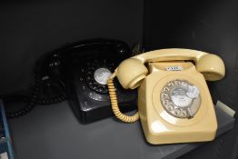 Two mid century rotary dial telephones.