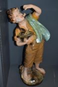 An early 20th Century kitsch plaster statue, in the form of a Cherry Boy, measuring 66cm tall